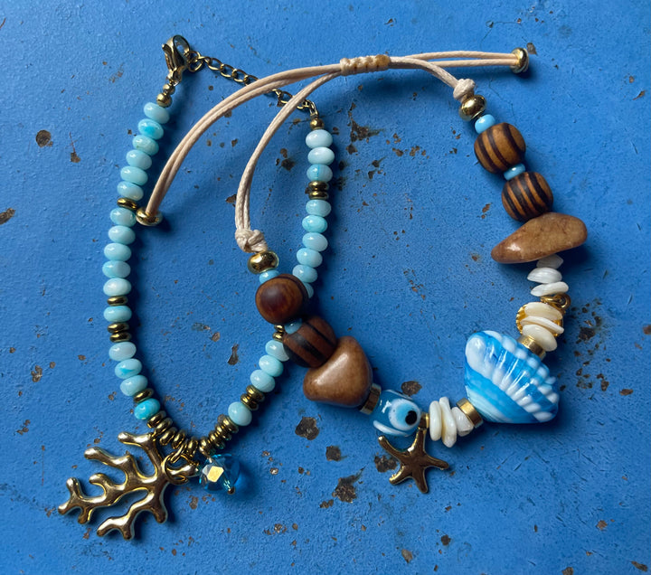 Scallop shell bracelet with wooden beads and gold charms.