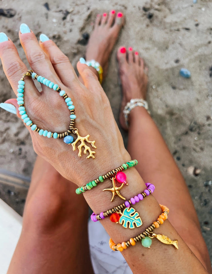 Purple shell beads with tropical leaf charm bracelet