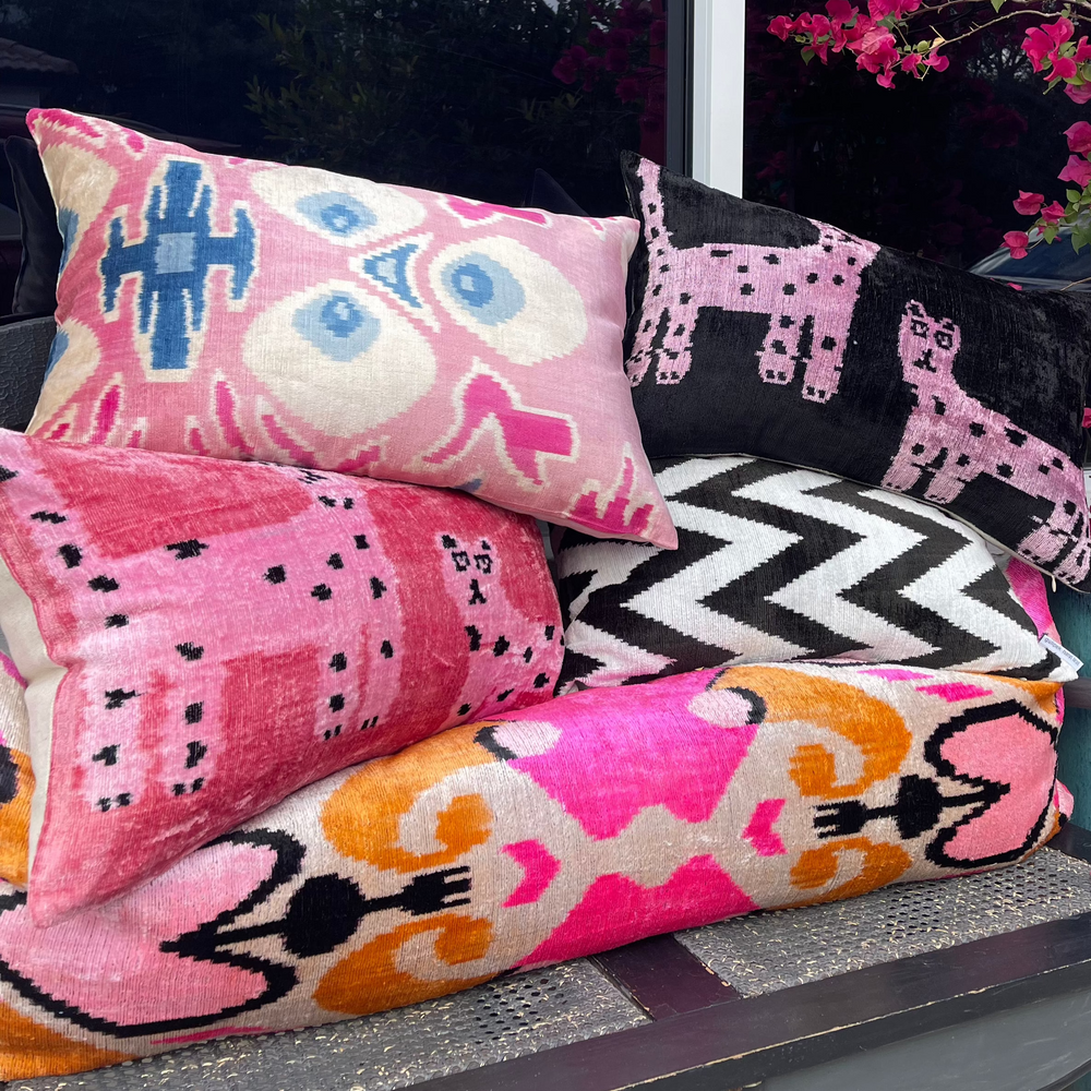 Material World hot-color hand-loomed throw pillows in passionate pink and black-and-white patterns, highlighting boho-chic styling from materialworld.design